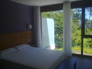Ein Bett oder Betten in einem Zimmer der Unterkunft Hotel Alén do Mar