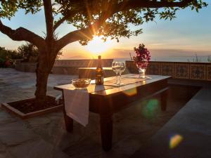 a table with wine glasses and a bottle of wine at Antonio Massa Lubrense in Massa Lubrense +73 photos