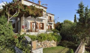 a small stone house with a stone wall at Anastasia Apartments in Stoupa