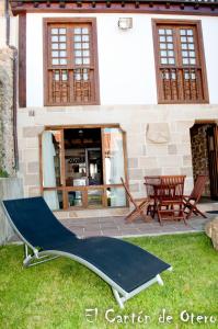 a hammock on the grass in front of a house at Estudios El Canton de Otero in Santillana del Mar