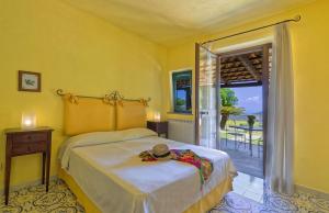 a bedroom with two beds and a door to a patio at Agriturismo Pera Di Basso in Ischia