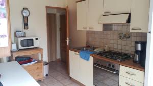 a kitchen with a sink and a stove top oven at Gîtes sains Baie du mont saint Michel LES HORTENSIAS in Sains +2 photos