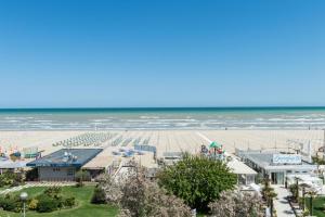 an aerial view of a beach with a resort and the ocean at Kiss Beachfront Hotel & Restaurant in Cervia