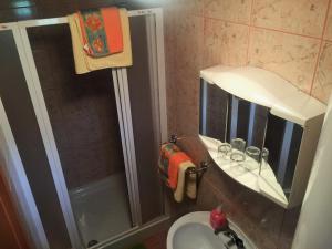 a bathroom with a sink and a shower with a mirror at Homestay J&M in Bled