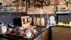 a kitchen with a counter with plates of food at Schmelmer Hof Hotel & Resort in Bad Aibling