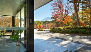 a view from the inside of a house with a patio at Motosu Phoenix Hotel in Fujikawaguchiko