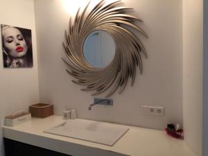 a bathroom with a sink and a mirror on the wall at Beautiful LOFT in the Center of Brussels in Brussels