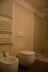 a bathroom with a toilet and a sink and a shower at Il Fortino - The Refuge in Sarzana