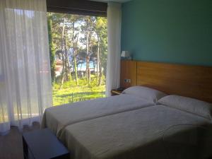 Ein Bett oder Betten in einem Zimmer der Unterkunft Hotel Alén do Mar