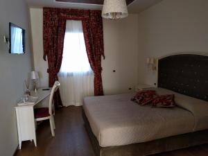 Postel nebo postele na pokoji v ubytování Agriturismo De Luca