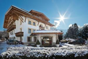 a large building with snow on the ground at Gartenhotel Maria Theresia in Hall in Tirol +69 photos