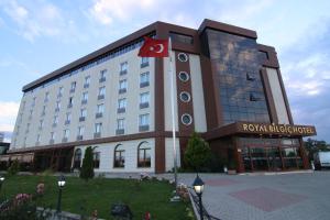 a building with a red flag in front of it at Royal Bilgic Hotel in Kırklareli