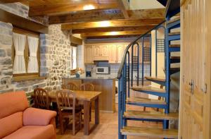 a kitchen and dining room with a staircase and a table at Casa el Parque Cajal in Torla-Ordesa