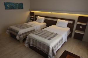 Postel nebo postele na pokoji v ubytování Royal Bilgic Hotel