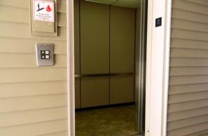 a door to a building with a sign on it at Stay Inn & Suites - Stockbridge in Stockbridge