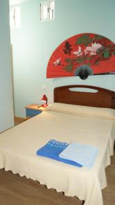 a bedroom with a bed with a wooden head board at Casa Huésped Magdalena in Madrid