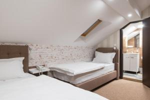 Letto o letti in una camera di Centrum Sobe Rooms Čačak