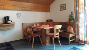 a dining room with a table and two chairs at Apart Martina in Ried im Oberinntal