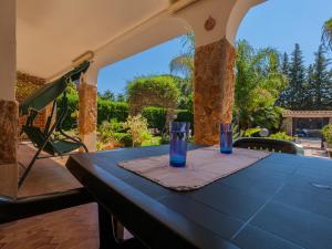 a blue table with two glasses on a patio at Villa Giovanna in Arenella