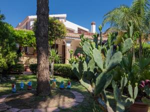 a garden in front of a house with cactus at Villa Giovanna in Arenella