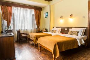 Cama ou camas em um quarto em Hotel Excelsior