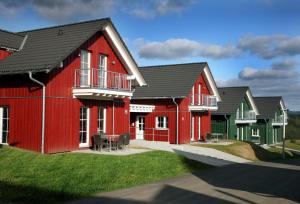 a row of houses with red at Nürburgring Ferienpark in Nürburg