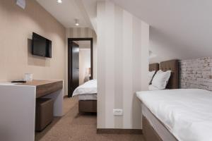 Letto o letti in una camera di Centrum Sobe Rooms Čačak