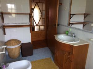 Un baño con lavabo, inodoro y espejo. en Avó das Bolachas House, en Famalicão 38 fotos más