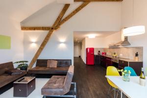 a kitchen and living room with a red refrigerator at GADEN Apartment - Hotel in Waging am See