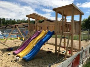 a playground with a slide in the sand at MobyDick Luxury Beach Apartment in Siófok