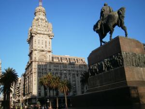 a statue of a man on a horse in front of a building at New Arapey Hotel in Montevideo