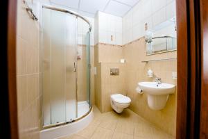 a bathroom with a shower and a toilet and a sink at Hotel Stal in Stalowa Wola +51 photos
