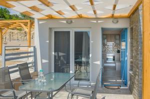 a patio with a table and chairs and a kitchen at Arina Villa in Skala Marion