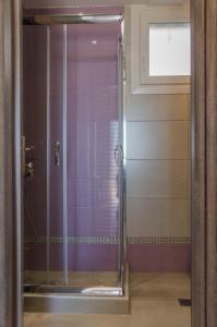 a shower with a glass door in a bathroom at Arina Villa in Skala Marion +33 photos