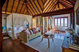 a living room with a bed and a couch and a tub at Sentidos Beach Retreat in Miramar