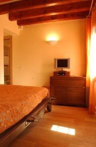 a bedroom with a bed and a tv on a dresser at Ca' Dei Dogi in Venice