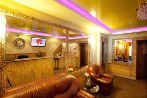 a living room with leather furniture and a bar at Hotel Nataly on Srednemoskovskaya 7 in Voronezh