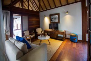 a living room with a couch and a table at Sentidos Beach Retreat in Miramar