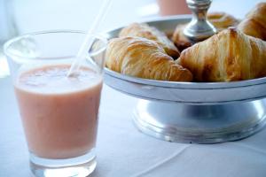 a plate of croissants and a glass of a drink at Oxbow Country Estate in Bronkhorstspruit
