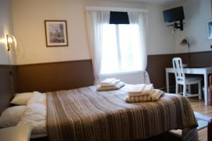Postel nebo postele na pokoji v ubytování Lugnet Malung Hotell