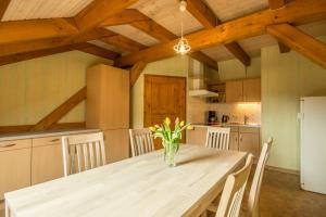 a kitchen with a table with a vase of flowers on it at Ferienwohnungen Ender in Sebnitz