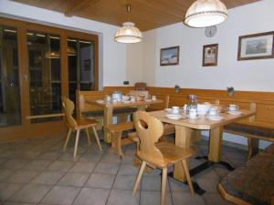 a dining room with wooden tables and chairs at Ferienhaus Römerhütte in Heiligenblut
