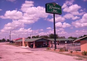 a sign for a wisconsin inn in front of a building at Western Inn Hamilton in Hamilton