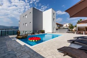 a swimming pool with a toy in the middle of a house at Luxury Villa ARIA, Apartment in Trogir