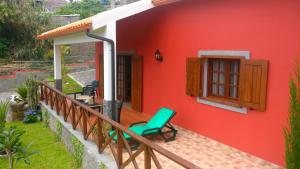 a red house with a deck with a fireplace at Casa del Mar in Santana