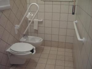 a bathroom with a toilet and a sink at Etna Inn in Motta SantʼAnastasia +15 photos