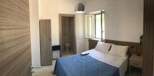 a bedroom with a blue bed and a window at Locazione Turistica Il Tucano in Agrigento +152 photos