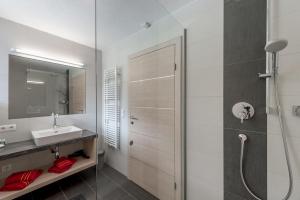 a white bathroom with a shower and a sink at Apart Armin in Längenfeld +94 photos