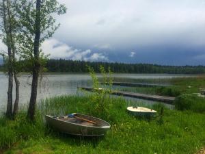 two boats sitting on the shore of a lake at Guest house Ura Seliger in Sloboda