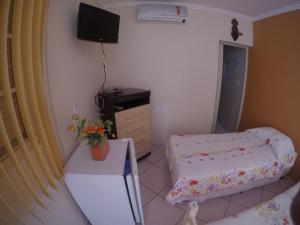 a small room with a bed and a tv at Pousada da Nona in Aparecida +20 photos